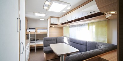 Luxuscamping - Art der Unterkunft: Campingfahrzeug - Innenansicht Etagenbetten und Sitzecke, diese kann zu einem weiteren Doppelbett umgebaut werden - Kirchzarten / Schwarzwald Luxuswohnwagen Premium in Kirchzarten / Schwarzwald