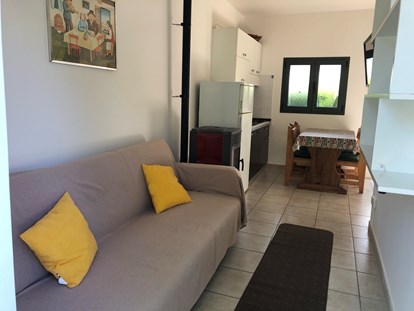Luxury camping - Lombardy - Couch und Essecke im Bungalow auf Camping Montorfano  - Camping Montorfano Bungalows