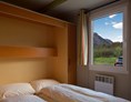 Glampingunterkunft: Zimmer im ein Residence Chalet - Klassische Mietchalets am Camping de la Sarvaz