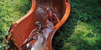 Luxuscamping - Österreich - Wasserrutsche am eigenen Badesee - Nature Resort Natterer See Safari-Lodge-Zelt "Rhino" am Nature Resort Natterer See