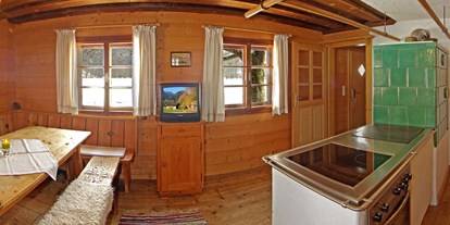 Luxuscamping - Art der Unterkunft: Bungalow - Pinzgau - gemütliche Stube mit Kachelofen - Grubhof Almhütte Steinbach Stube im Almdorf Grubhof