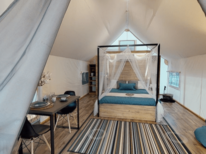 Luxury camping - Lagerfeuerplatz - Lakeside romantic Tent Schlafzimmer mit Doppelbett, Schlafcouch und Essbereich - Lakeside Petzen Glamping Resort