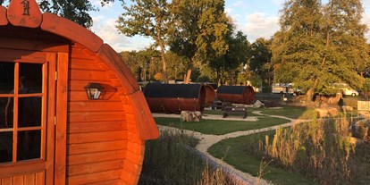 Luxuscamping - Terrasse - Schlaffässer mit schöner Anlage und alter Baumbestand runden das Dorfambiente ab. - Campingpark Heidewald Campingpark Heidewald