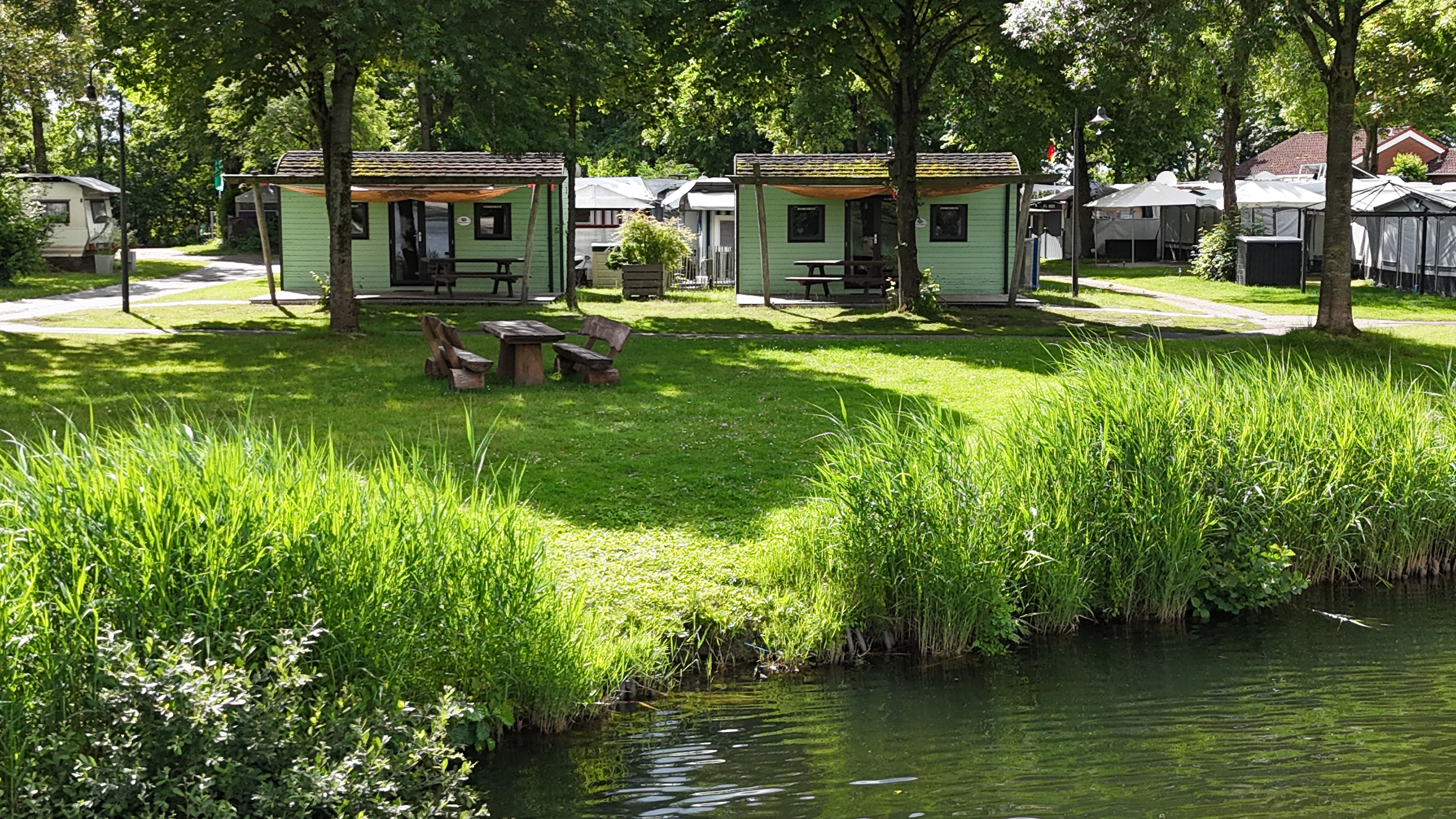 Luxuscamping: Die Woodlodges auf dem Campingplatz am Emsdeich Ostfriesland nahe der Nordsee versprechen Urlaub mit der Familie inmitten der Natur. - Freizeitpark "Am Emsdeich": Family Woodlodge mit Seeblick auf dem Freizeitpark "Am Emsdeich"