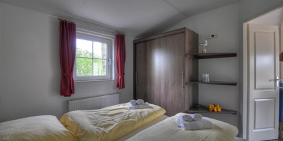 Luxuscamping - Heizung - PLZ 23769 (Deutschland) - Das Schlafzimmer mit Doppelbett. - Camping- und Ferienpark Wulfener Hals Ferienhaus Seemöwe 4 Personen am Camping- und Ferienpark Wulfener Hals
