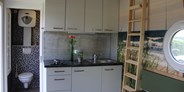 Luxuscamping - PLZ 49597 (Deutschland) - Küchenbereich mit geöffneter WC Tür
Tiny Ey - Tiny Ferien- und Ausstellungspark