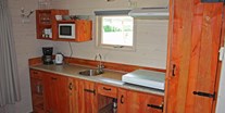 Luxuscamping - Badewanne - Küche - Camping De Kleine Wolf Oehoe Lodge auf Campingplatz de Kleine Wolf