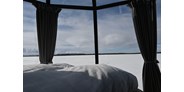 Luxuscamping - Nordschweden -  Am EinMorgen ein wunderschöner Ausblick auf den gefrorenen See. - Laponia Sky Hut