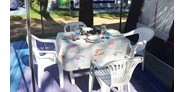 Luxuscamping - Italien - Sitzbereich Terrasse  Deluxe Caravan A127 - Wohnwagen DELUXE A127 Bad mit Dusche Waschbecken WC TV Klimaanlage Vorzelt mit Holzboden Küche Waschmaschine 5 Personen von WMC BUSCHMANN camping-in-venedig auf Camping Union Lido
