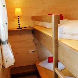 Glamping: Ferienhütte "Drachenwand": Kinderzimmer mit einem Stockbett - CAMP MondSeeLand